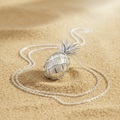 Ananas sterling silver pineapple necklace on sand