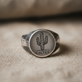 Cactus silver signet ring on linen