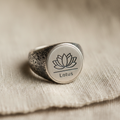 Lotus silver signet ring on linen