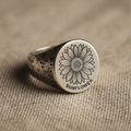 Sunflower silver signet ring on linen