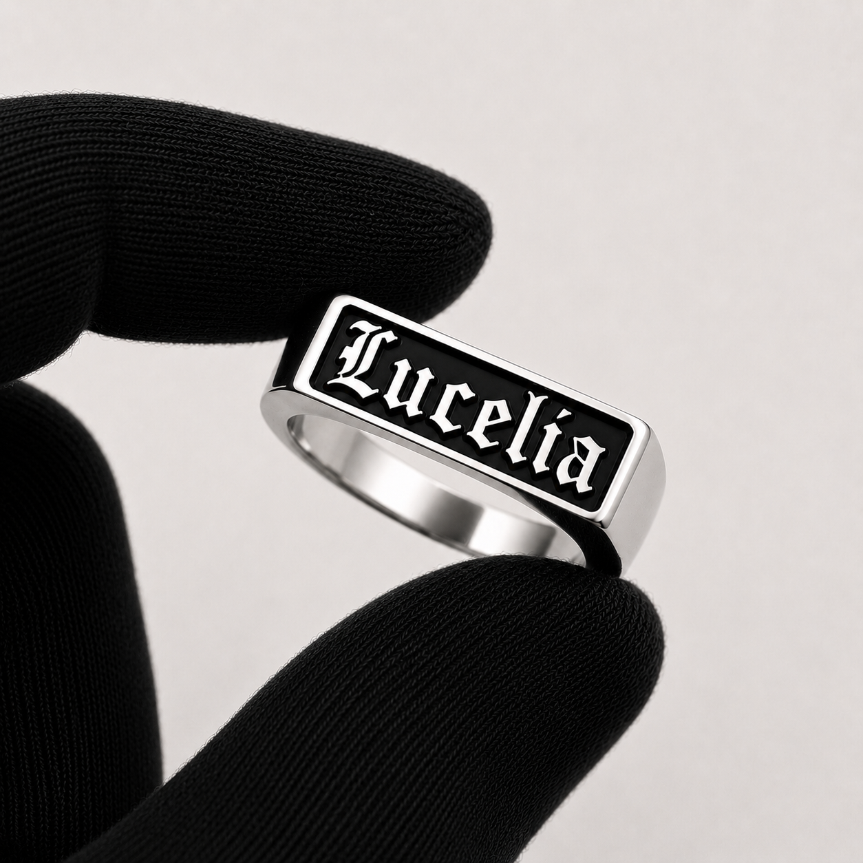 Lucelia signet ring held between fingers - ANANAS